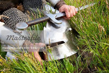 Knight's helmet and sword /  wet after rain