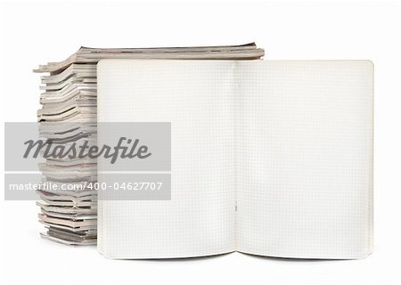 squared exercise book and magazines on white, visible natural shadow in front