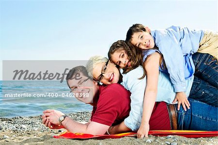 Portrait of a happy family having fun on a beach