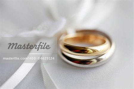 Wedding rings on a blue satiny fabric. Depth of field