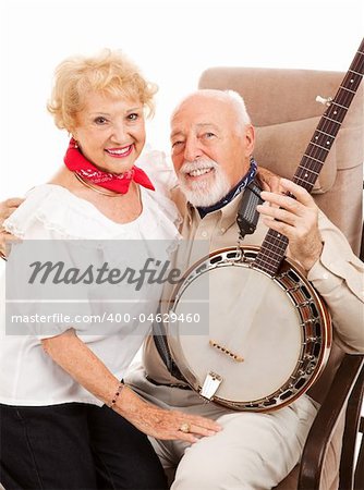Country western senior musician with his wife and his banjo on his lap.  Isolated.