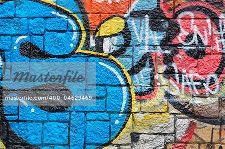 Stone wall surface covered with graffiti. Urban background.