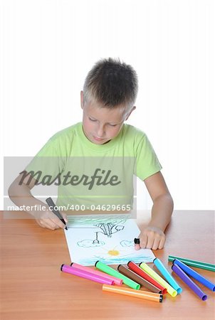 Cute child, focused, drawing on white paper, isolated