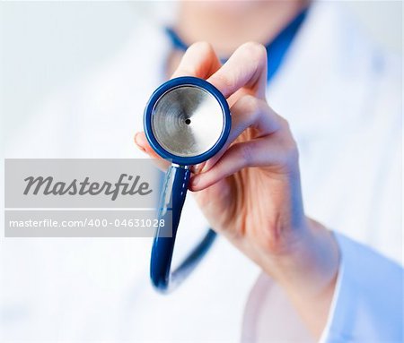 Female Doctor holding out stethescope