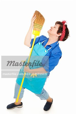 Lonely housekeeper dancing with her broom.  Full body isolated on white.