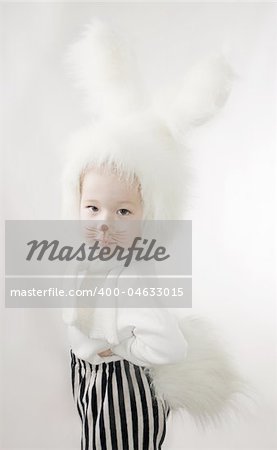 little girl in a white downy bunny costume.