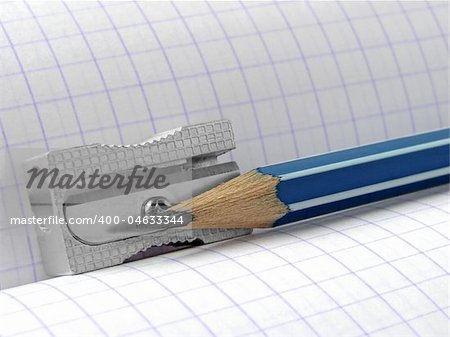 sharpener and pencil on the workbook page