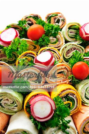 Closeup on platter of assorted meat tortilla wraps