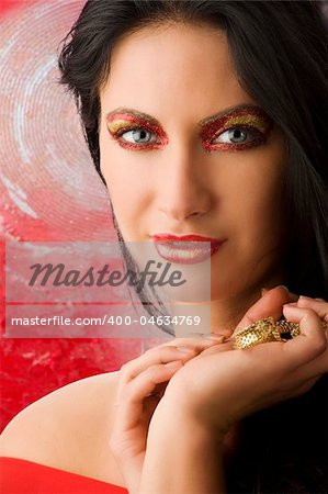 beautiful brunette with shining creative make up red and golden looking in camera