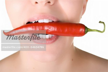 girl close up with chili pepper at her lips isolated on white