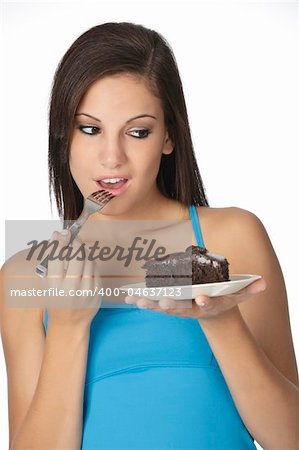 Beautiful Caucasian woman eating a slice of chocolate cake