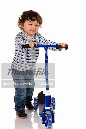 little boy riding scooter