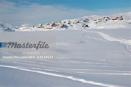 A small inuit village lost in a snowy landscape