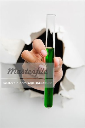 Hand holding tube filled with green solution mean breakthrough in pharmacy(medicine) and chemistry - one of the breakthrough series