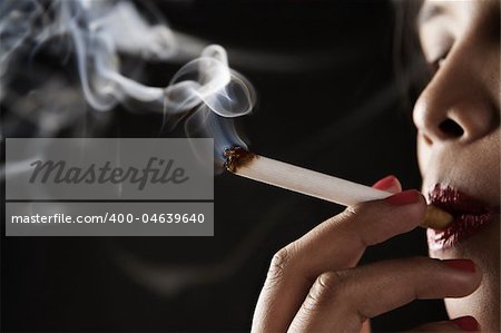 Woman smoking on dark area