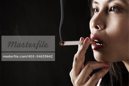 Woman smoking on dark area