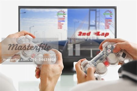 male hands holding game-pads, playing racing game. The image and design on screen are mine.