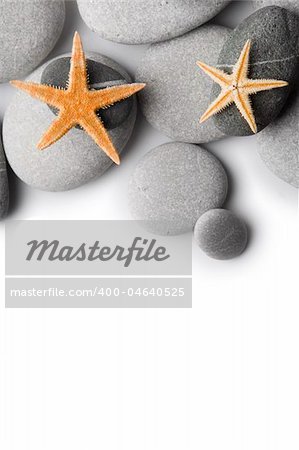 Starfish on Pebbles as a border with a white background