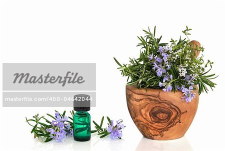Rosemary and thyme herb leaf sprigs with flowers in an olive wood mortar with pestle and an aromatherapy essential oil glass bottle, over white background.
