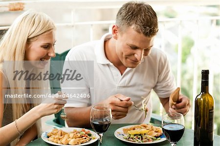 Young couple dining at home and having good time