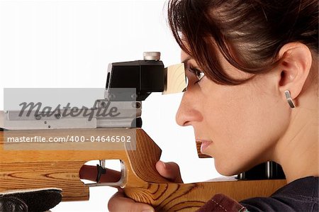 beautiful young woman aiming a pneumatic air rifle