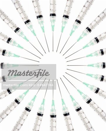 Stock image of symmetrically arranged syringes on a circle, isolated on white