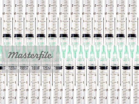 Stock image of symmetrically arranged syringes, isolated on white