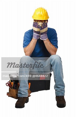 desperate young handyman sit on his toolbox