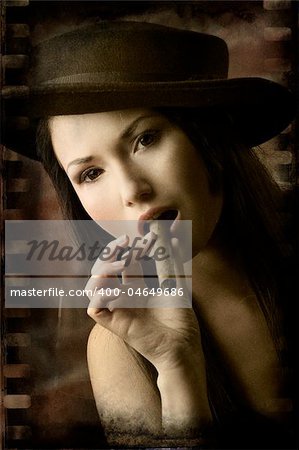 portrait of pretty young asian girl with black hat smoking a cigar