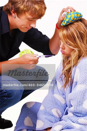 Teenage boy taking care of his sick girlfriend