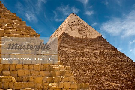 Base of a pyramid in the foreground with another pyramid in the background on a sunny day