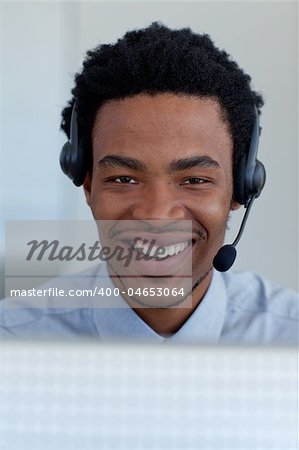 Portrait of a smiling Afro-American businessman working in a call center