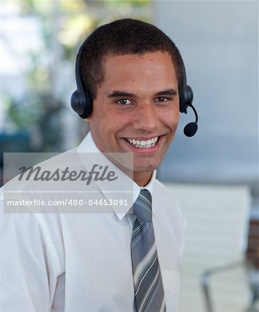 Attractive businessman with a headset on working in a call center