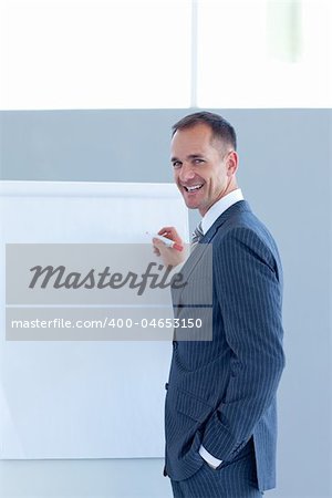 Mature businessman giving a presentation to his team