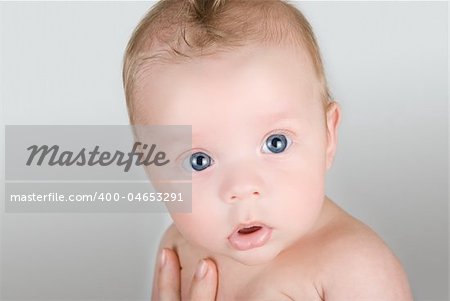 Beauty baby boy at mother hand isolated on a white background