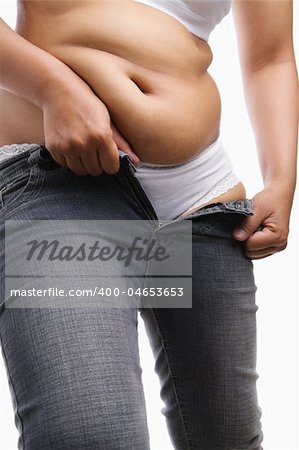 Fat woman trying to wear tight jeans, a concept for obesity issue