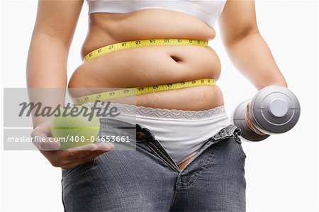 fat woman with unzup jeans holding apple and weight on each hand, id a concept to fight against obesity
