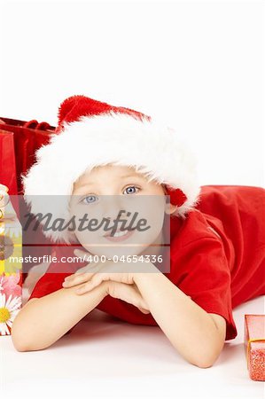 Portrait of little boy in a cap santa with gifts, isolated