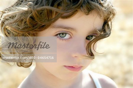 Beautiful little girl portrait outdoor looking to camera
