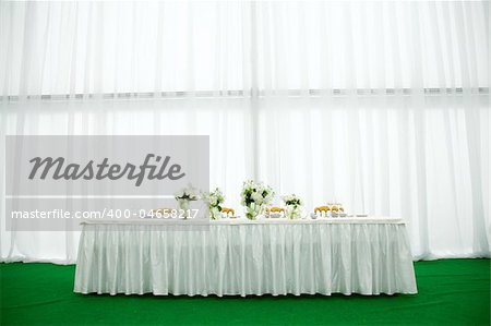 Elegant tables and chairs set up for a wedding banquet