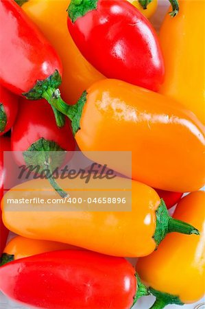 Orange, red & yellow Jalapeno Pepper background.