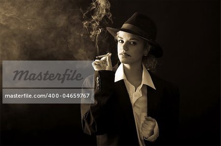 beautiful girl in a man's suit, smoke on black background