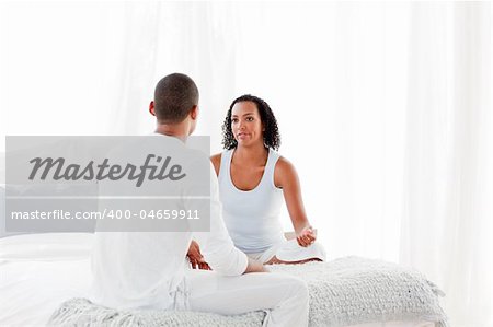 Woman and man having an argument on bed