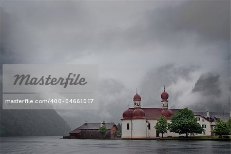 An orthodox church on lake shore on a stormy day