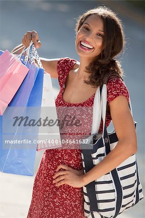 Young woman with shopping bags. Vertically framed shot.