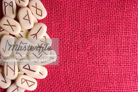 Runic stones, for astrological consultation, past, present and future. Red background.