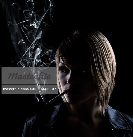 low key shot of a smoking woman on black background