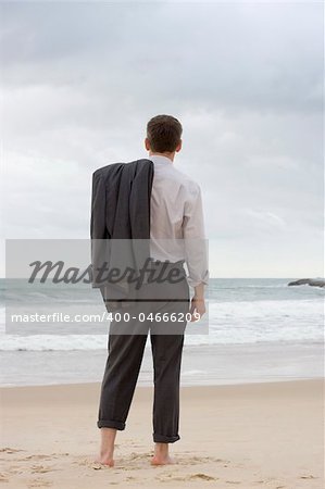 Barefoot businessman relaxing on a beach