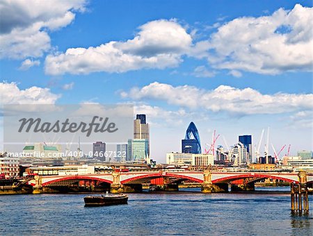 Blackfriars Bridge with London skyline behind from Thames river