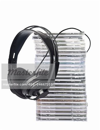 Stack of cd`s and headphones on white background